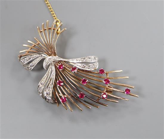 A modern 9ct gold, ruby and diamond set stylised spray brooch, 55mm.